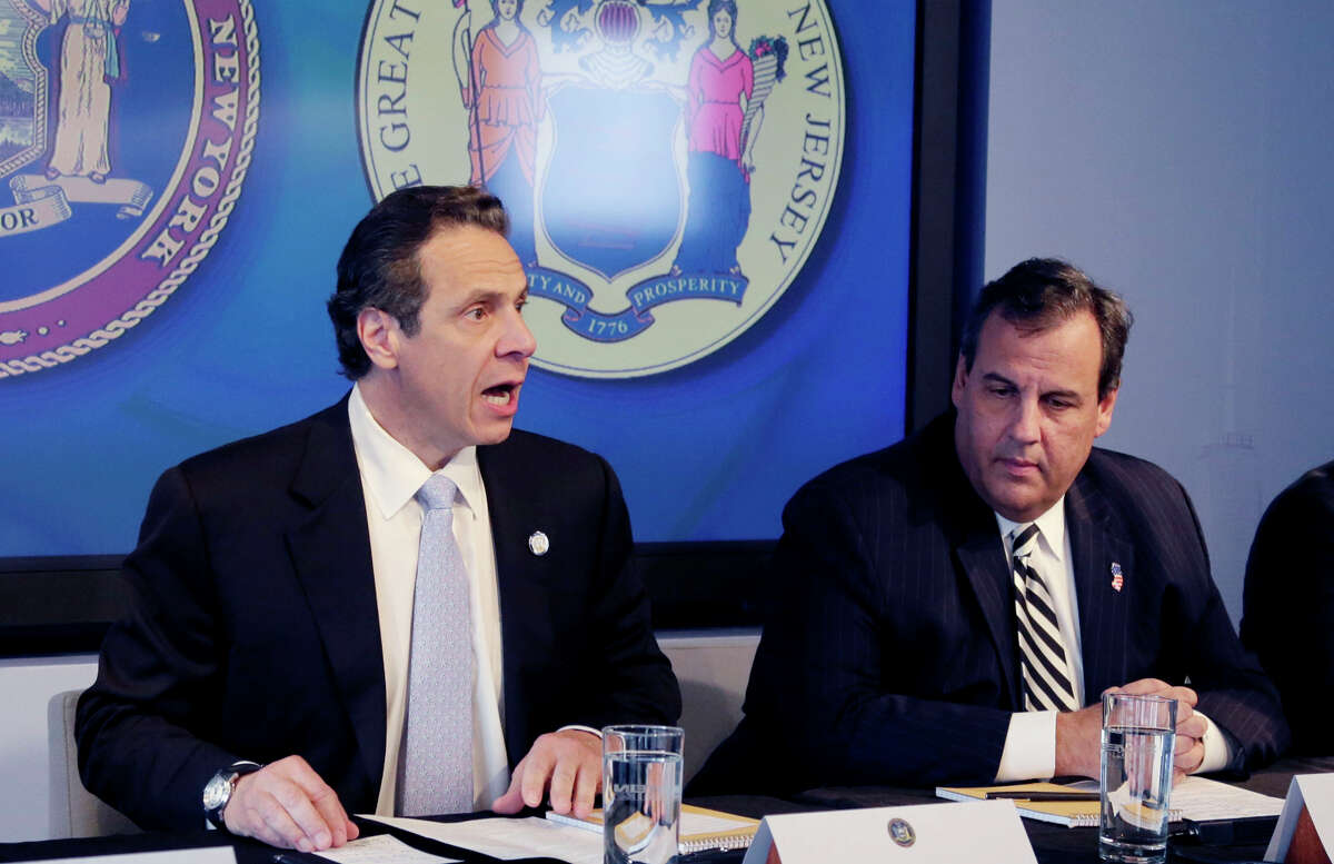 New York Gov. Andrew Cuomo (left) and New Jersey Gov. Chris Christie announce a quarantine Friday.