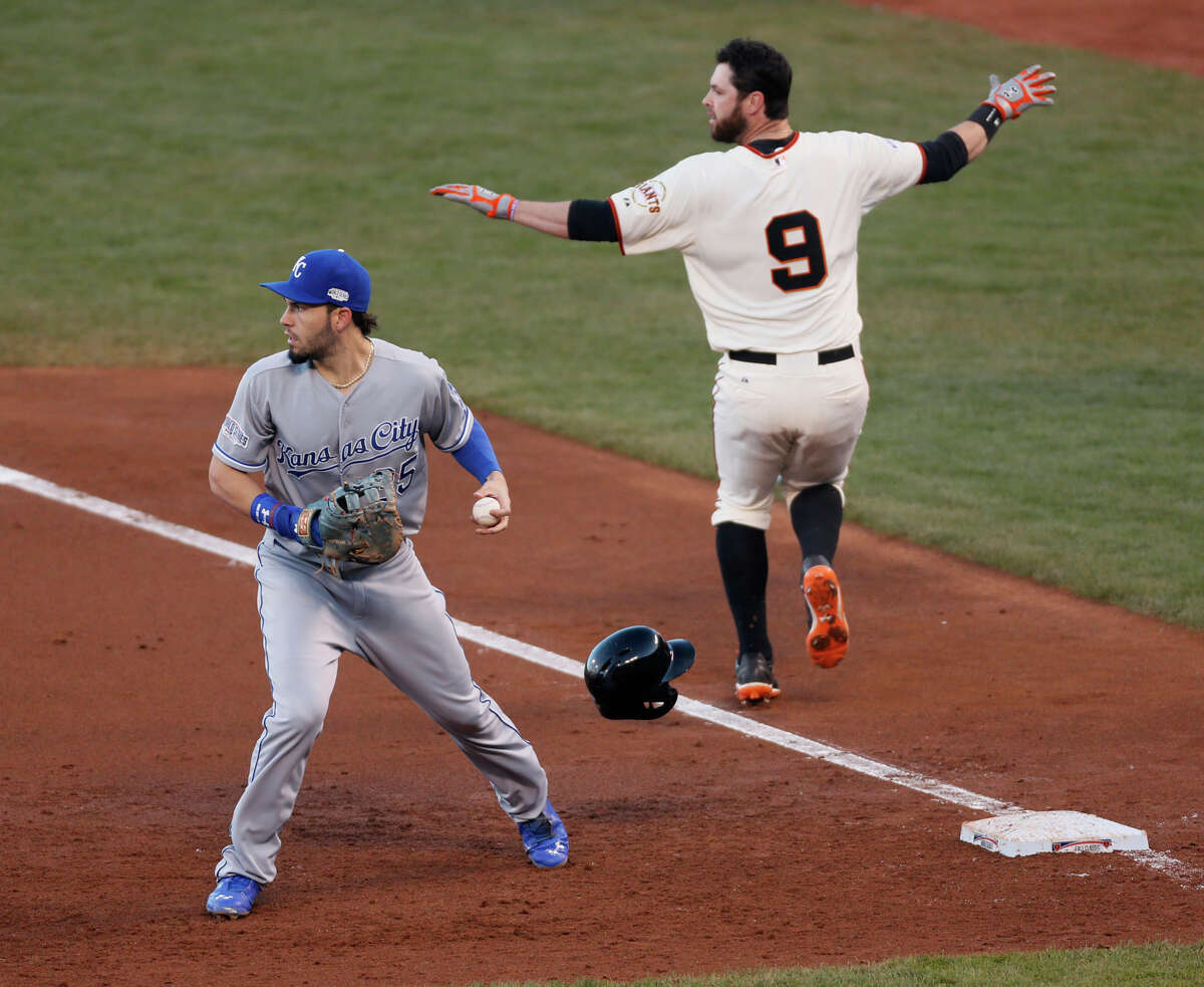 Brandon Belt makes the call as he reaches first on a bunt, a play that helped set up the Giants’ first run in the second inning.