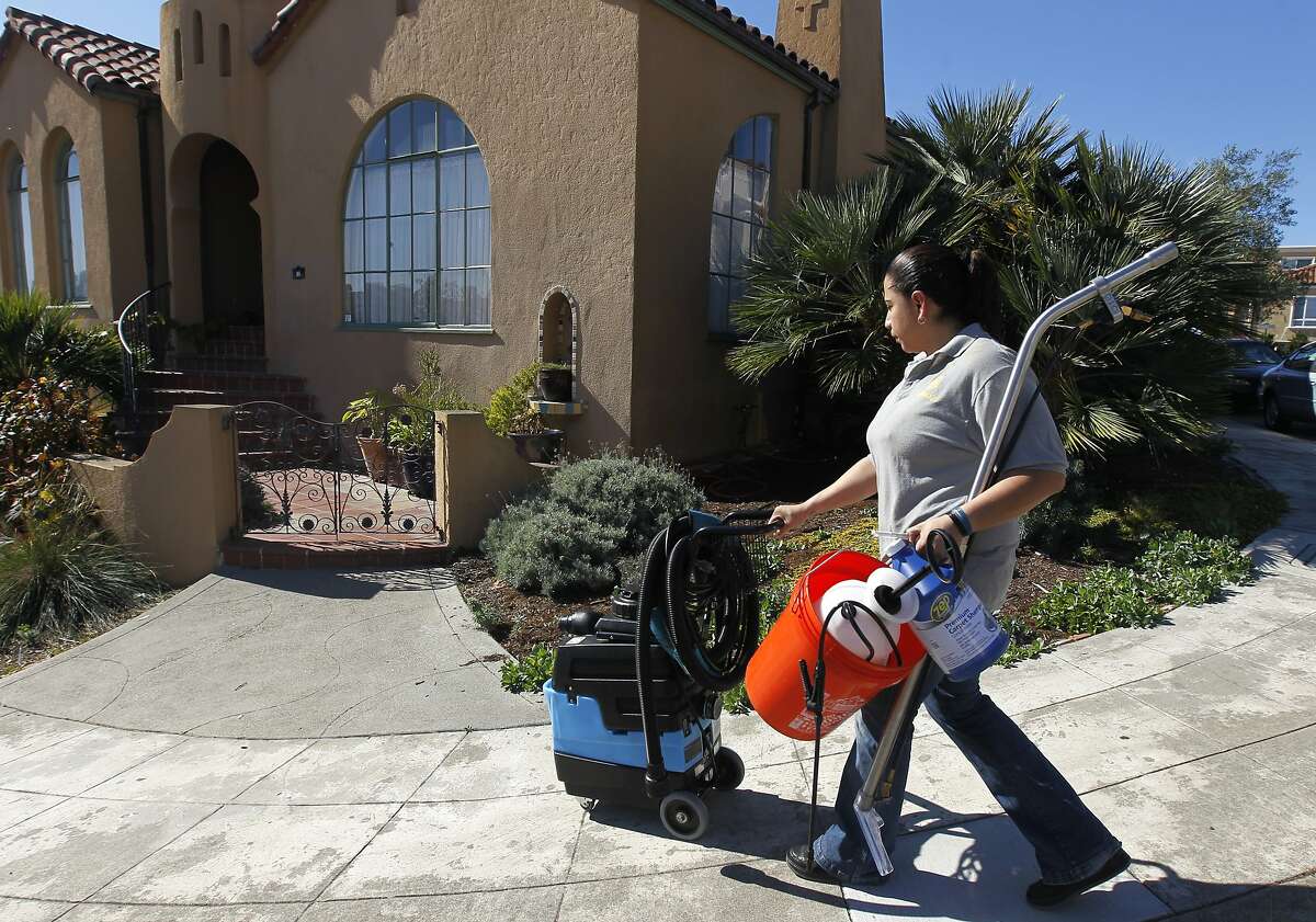 Rosa Sanchez, a carpet and upholstery cleaner for Homejoy, arrives with steam cleaning equipment at Rie Yamazaki-Bach's home in San Francisco, Calif. on Tuesday, Oct. 28, 2014. Many homeowners are turning to Homejoy to connect with maintenance services such as carpet cleaning, plumbing and painting.