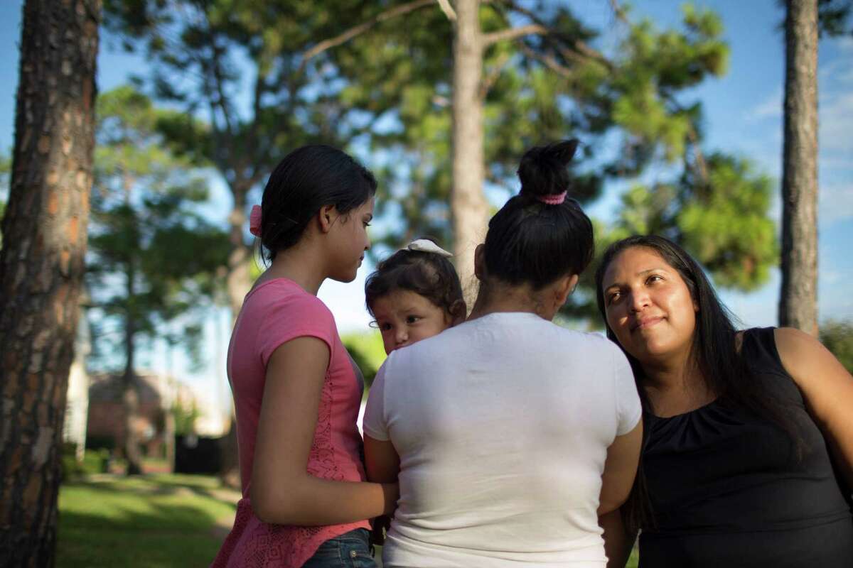 Claudia Palma, right, left Honduras after enduring domestic violence and was separated from her daughters, pictured with a granddaughter, for 14 years.