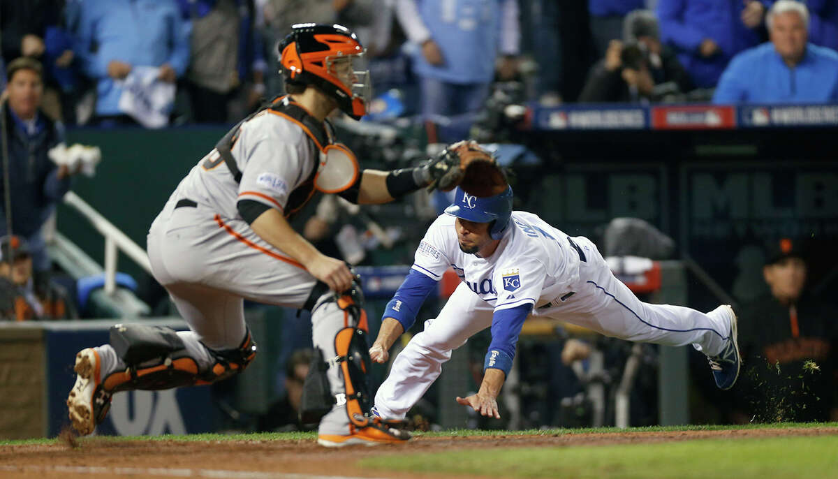 Royals Omar Infante dives home in the fifth inning during Game 6 of the World Series at Kauffman Stadium on Tuesday, Oct. 28, 2014 in Kansas City, Mo.