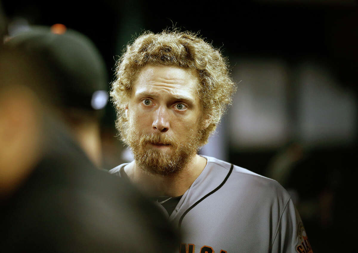 Giant Hunter Pence talks to a teammate before heading out to the field in the fifth inning during Game 6 of the World Series at Kauffman Stadium on Tuesday, Oct. 28, 2014 in Kansas City, Mo.