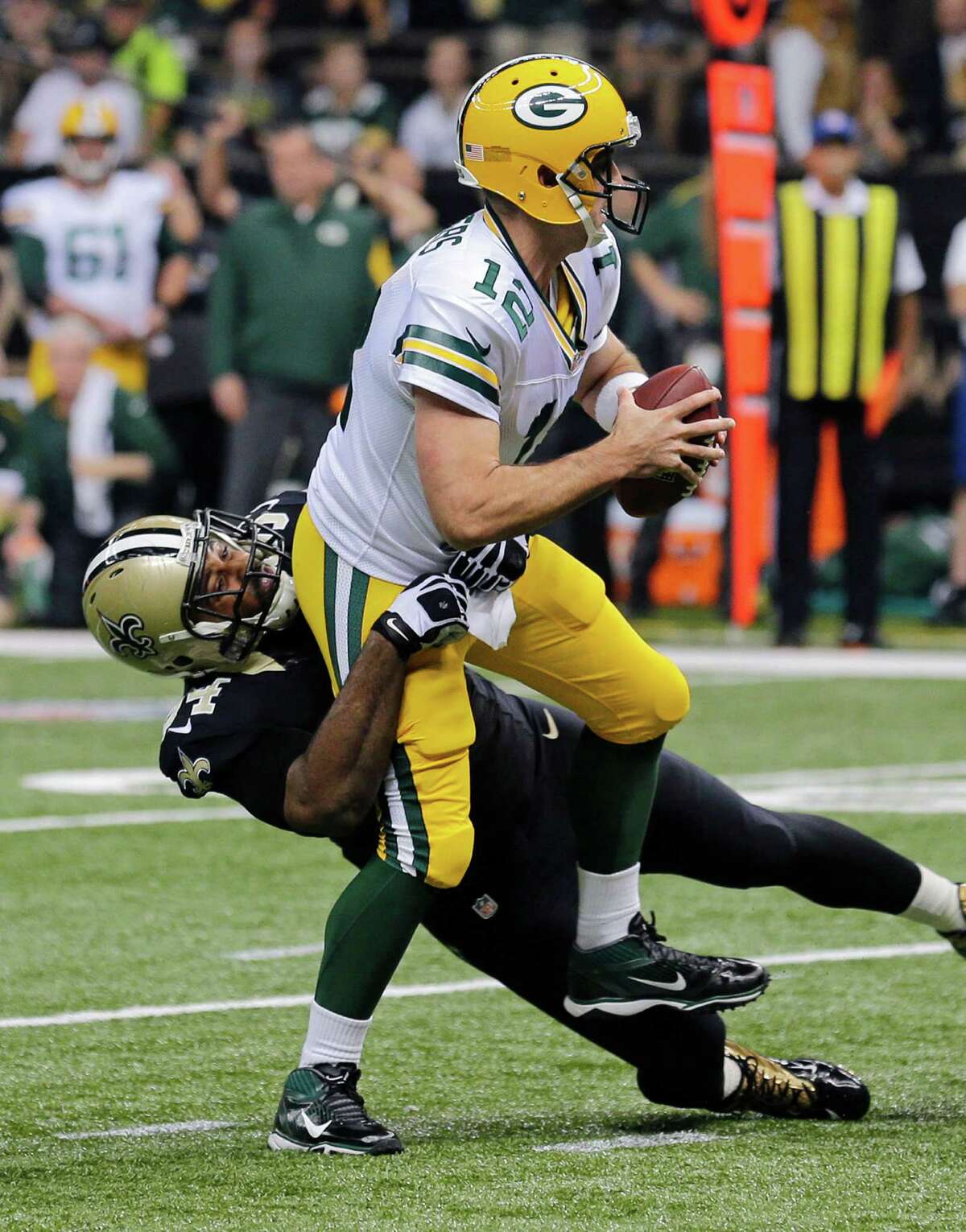 Green Bay Packers quarterback Aaron Rodgers (12) is sacked by New Orleans Saints defensive end Cameron Jordan (94) in the first half of an NFL football game in New Orleans, Sunday, Oct. 26, 2014. (AP Photo/Bill Haber)
