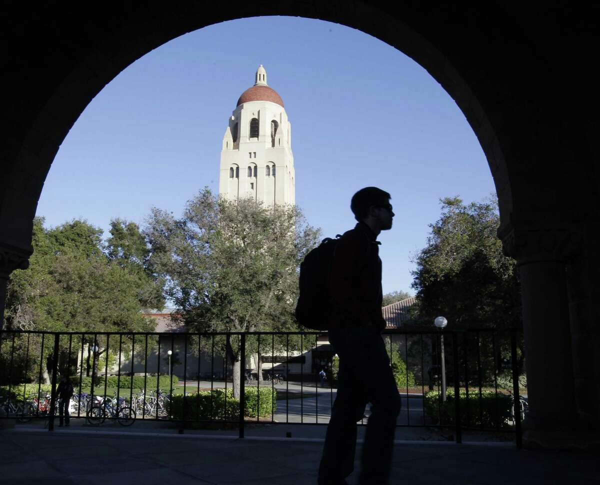 A Stanford University student walks in front of Hoover Tower on the Stanford University campus in Palo Alto, California. 