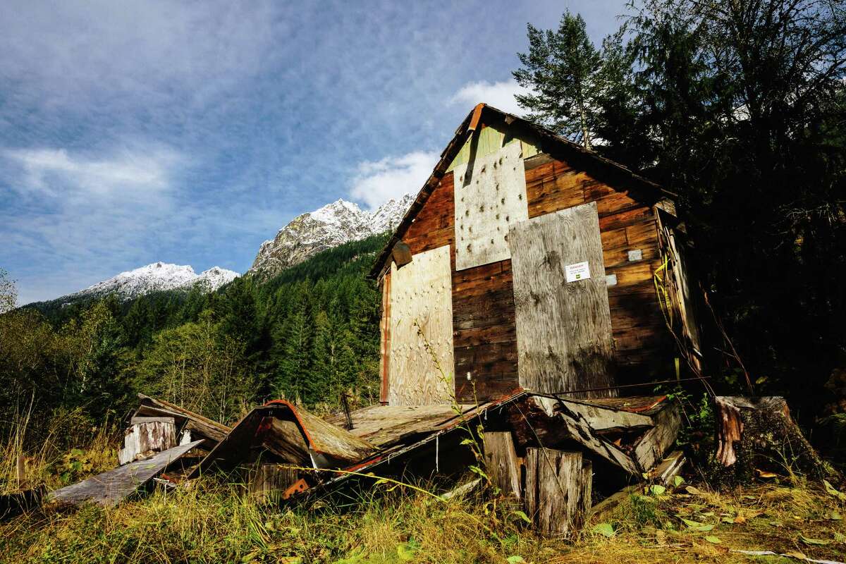 Snowcapped mountain ridges provide a stunning backdrop to the defunct mining town of Monte Cristo, photographed Monday, October 27, 2014.