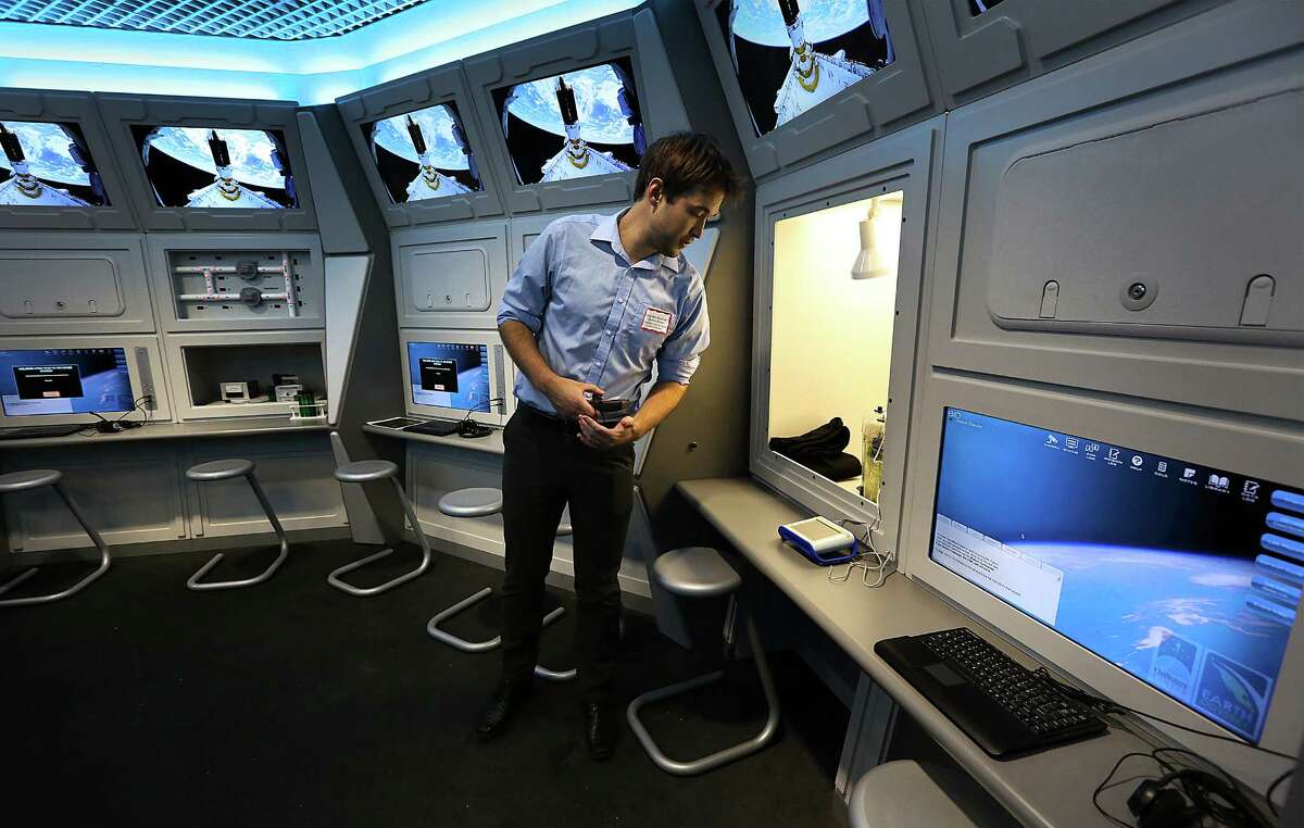 Brandon Bobinski, Education Manager of Challenger Center for Space Science, checks a display in the Challenger Learning Center. San Antonio College will open its new Scobee Planetarium, Observatory and Challenger Learning Center. Wednesday, Oct. 29, 2014.