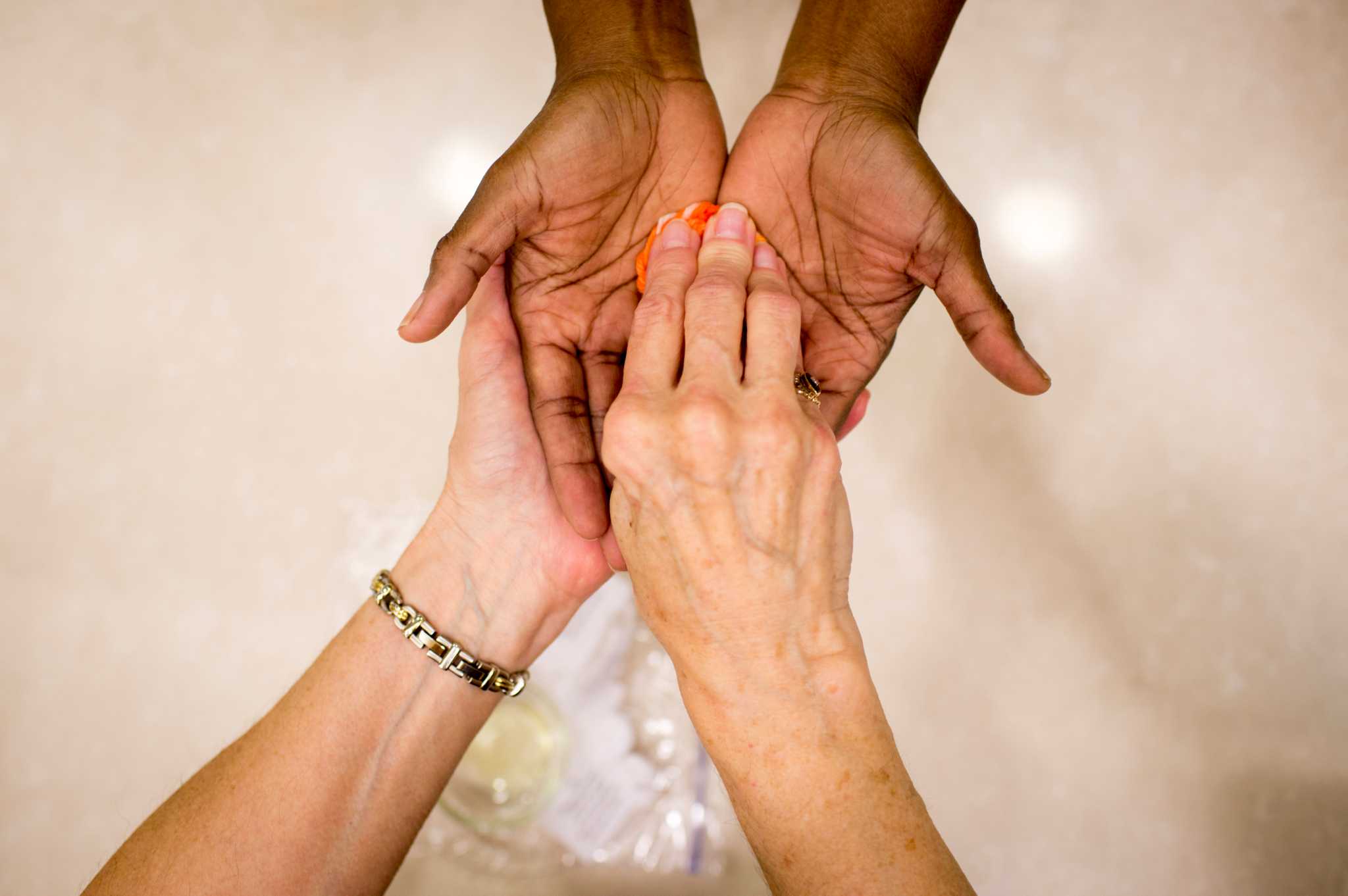 Hands of hospice workers blessed in prayerful ceremony