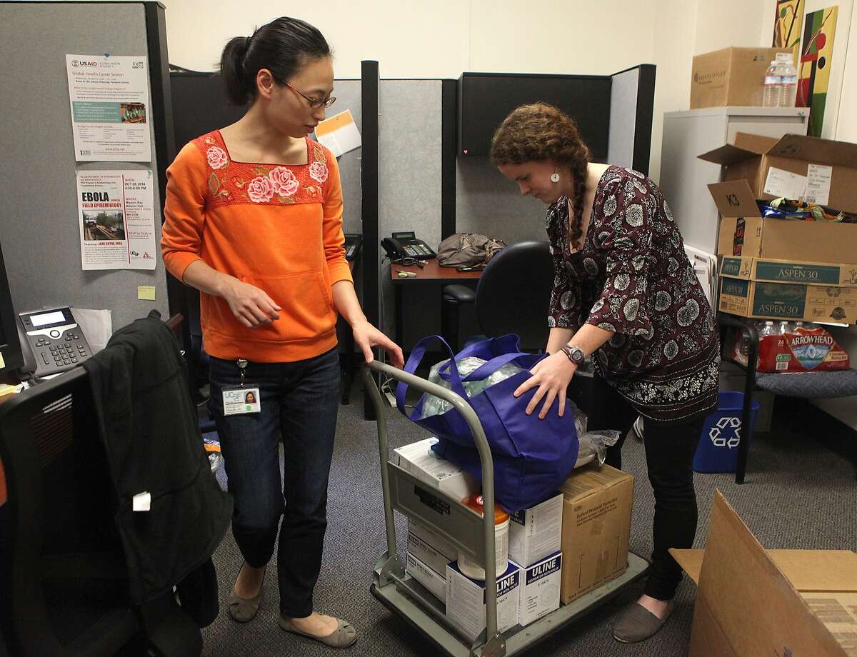 Dr. Ethel Wu (left) checks personal protective equipment from Direct Relief with research assistant Brett Lewis at UCSF in San Francisco, Calif., on Wednesday, October 29, 2014. Dr. Wu is leaving for Liberia tomorrow and is picking up protective equipment which will be used by the three UCSF doctors leaving to battle the Ebola epidemic.