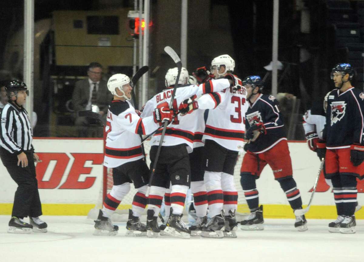 The Devils celebrate following a goal during their hockey game against Springfield at the Times Union Center on Wednesday Oct. 29, 2014 in Albany, N.Y. (Michael P. Farrell/Times Union)