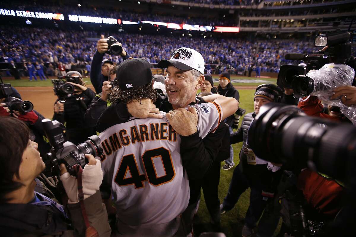 Giants Madison Bumgarner and Giants manager Bruce Bochy embrace after the Giants defeated the Royals 3 to 2 to win the World Series in Game 7 of the World Series at Kauffman Stadium on Wednesday, Oct. 29, 2014 in Kansas City, Mo.