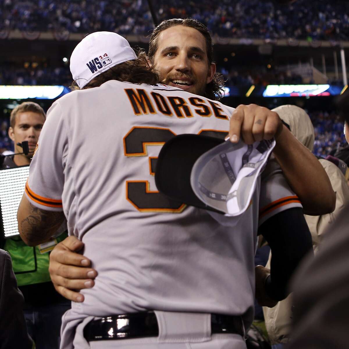 San Francisco Giants' Madison Bumgarner and Michael Morse hug after Game 7 of the World Series at Kauffman Stadium on Wednesday, Oct. 29, 2014 in Kansas City, Mo.