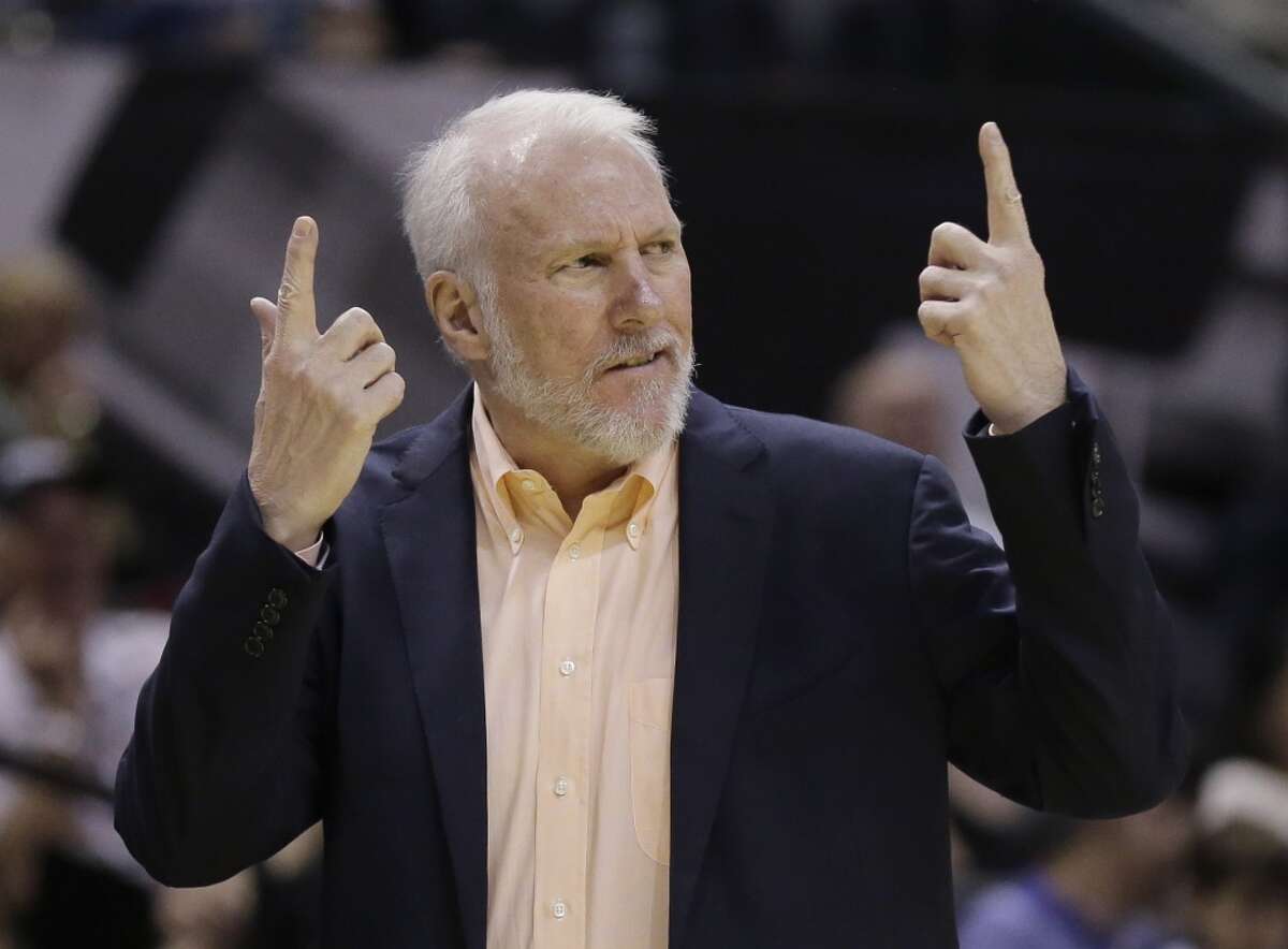 San Antonio Spurs' Gregg Popovich, looking a bit like an angry Sean Connery, questions a call during the first half of an NBA preseason basketball game against the Sacramento Kings, Monday, Oct. 20, 2014, in San Antonio. (AP Photo/Eric Gay)