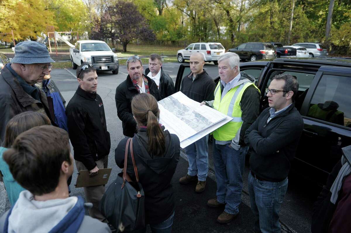 James Flynn, second from right, a project manager with Kinder Morgan, holds a map showing the company's gas pipelines for Federal Energy Regulatory Commission staff and representatives from the Town of Bethlehem on Thursday, Oct. 30, 2014, in Bethlehem, N.Y. Kinder Morgan is proposing to add a third pipe to a portion of the Tennessee Gas Pipeline. (Paul Buckowski / Times Union)