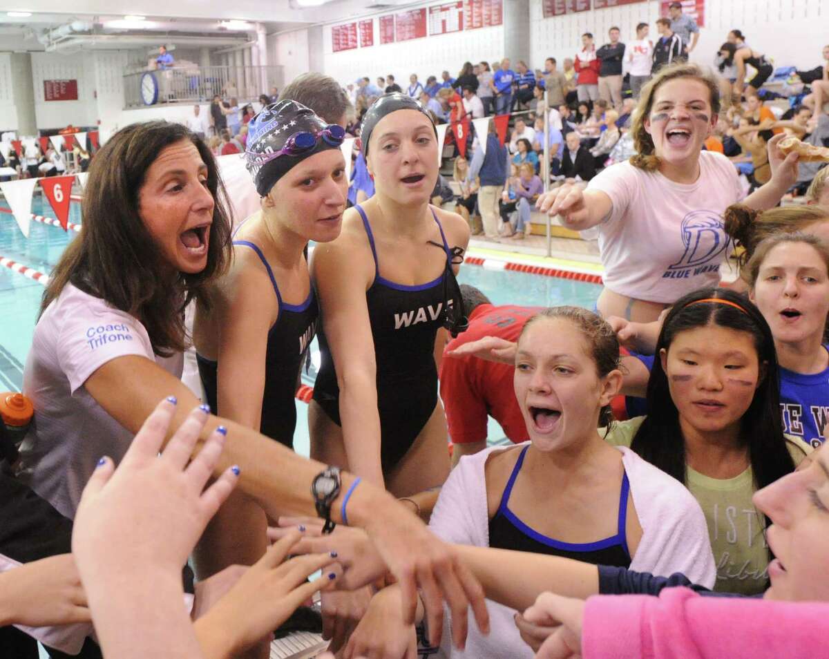 Darien High School girls swimming coach, Marj Trifone, left, with her team during the FCIAC Girls High School Swimming Championship at Greenwich High School, Greenwich, Conn., Thursday, Oct. 30, 2014. Darien won the meet taking the championship over New Canaan, the second place finisher.