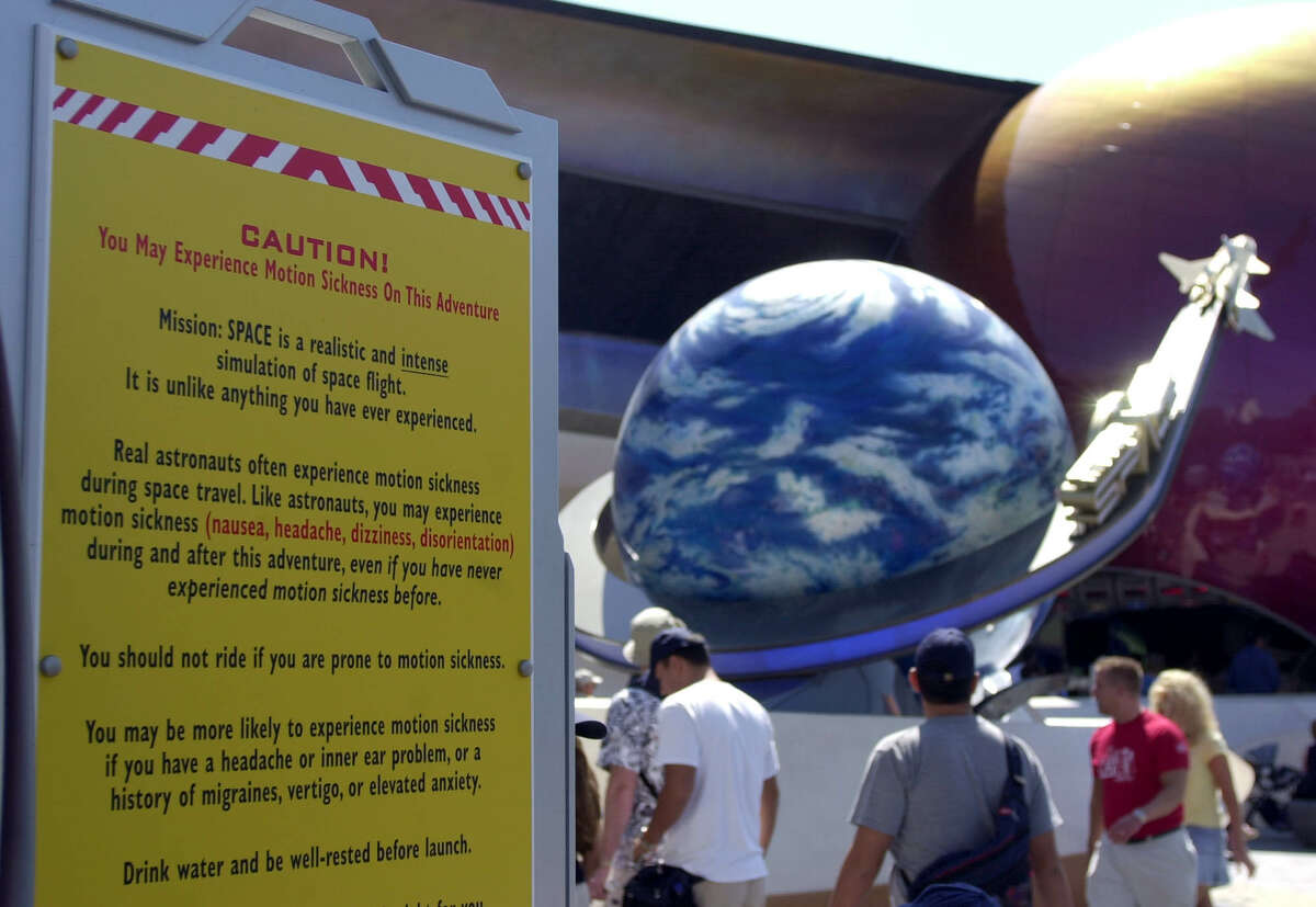 A caution sign alerts guests at Walt Disney World's Mission:Space that they may experience motion sickness on this ride.
