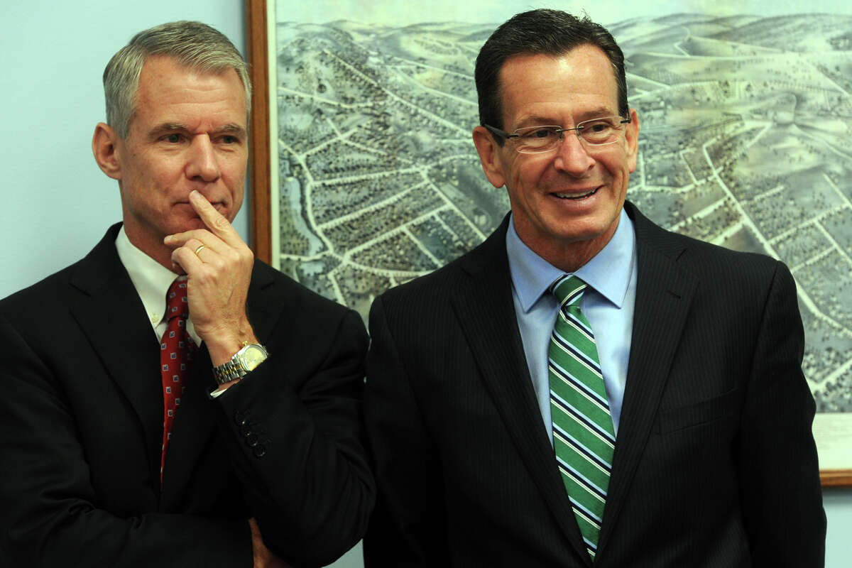 Gov. Dannel Malloy stands with Stephen Angel, Chairman, President and Chief Executive Officer of Praxair, Inc. during a meeting at the Greater Danbury Chamber of Commerce, in Danbury, Conn. Oct. 31, 2014. Praxair announced they will keep their world headquarters in Danbury, and will invest $65 million to build a new 100,000 square foot corporate facility.