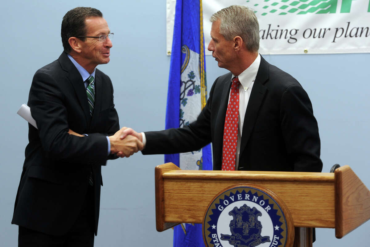 Gov. Dannel Malloy shakes hands with Stephen Angel, Chairman, President and Chief Executive Officer of Praxair, Inc. during a meeting at the Greater Danbury Chamber of Commerce, in Danbury, Conn. Oct. 31, 2014. Praxair announced will they keep their world headquarters in Danbury, and will invest $65 million to build a new 100,000 square foot corporate facility.