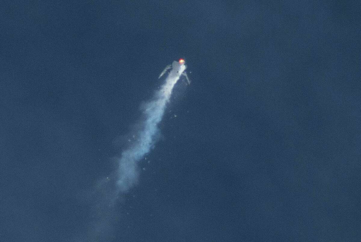 The Virgin Galactic SpaceShipTwo rocket explodes in the air during a test flight on Friday, Oct. 31, 2014. The explosion killed a pilot aboard and seriously injured another while scattering wreckage in Southern California's Mojave Desert, witnesses and officials said.
