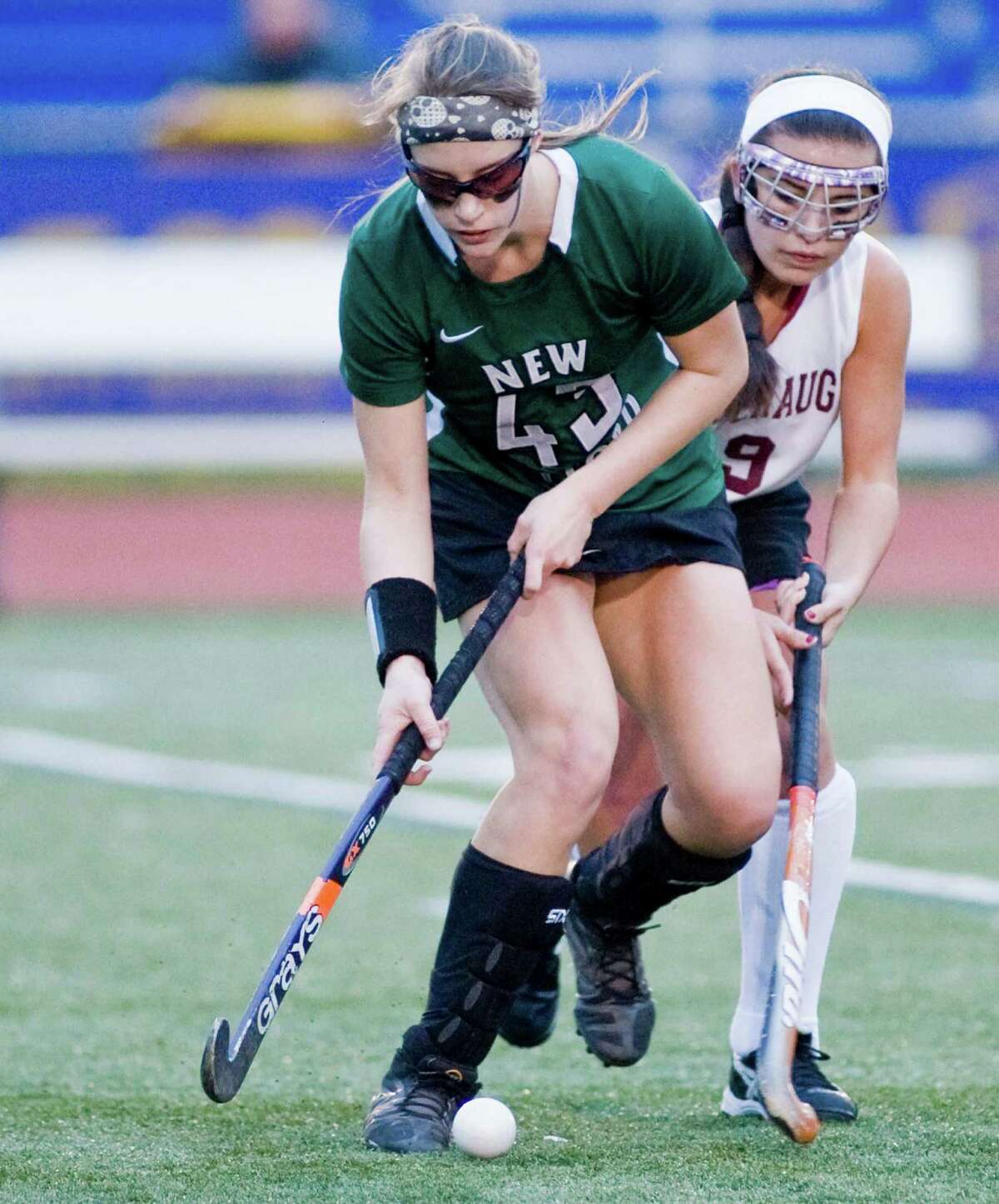 Natalie Capriglione of New Milford High School blocks out Joanna Rizza of Pomperaug High School during the SWC field hockey championship at Brookfield High School. Friday, Oct. 31, 2014