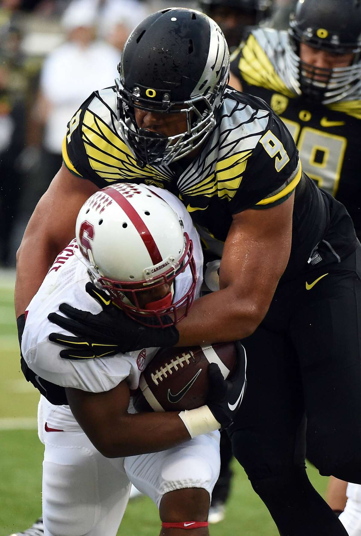 EUGENE, OR - NOVEMBER 1: Defensive lineman Arik Armstead #9 of the Oregon Ducks tackles running back Remound Wright #22 of the Stanford Cardinal during the first half of the game at Autzen Stadium on November 1, 2014 in Eugene, Oregon. (Photo by Steve Dykes/Getty Images)