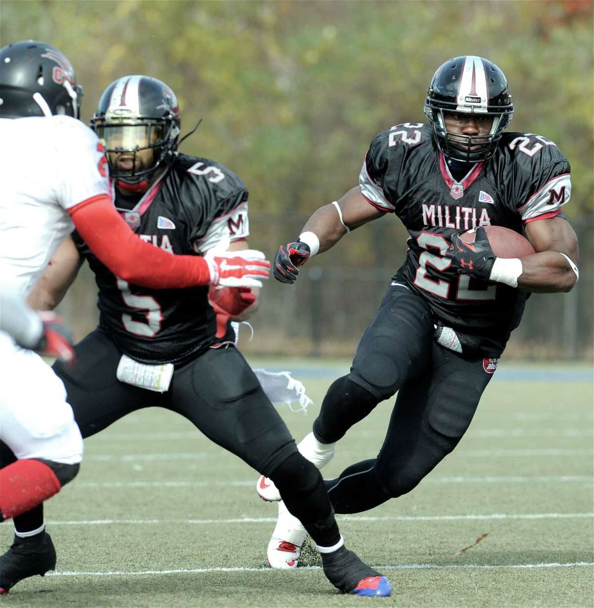 The Militia's Lionel Assie (22) cuts off a block by team mate Jason Davis (5) on Panthers Courtney Sutherland (2) during the New England Football League AAA semifinals between the Western Connecticut Militia and the Connecticut Panthers, on Sunday, November 2, 2014, at Waterbury Municipal Stadium, Waterbury, Conn.