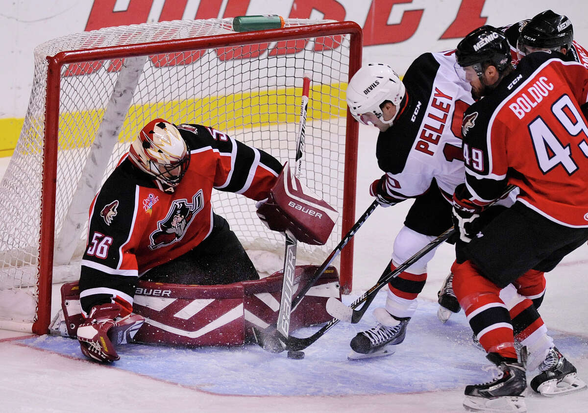 Rod Pelley of the Albany Devils tries to get to puck past goalie Mike McKenna of the Portland Pirates at the Times Union Center on Sunday, Nov. 2, 2014, in Albany, N.Y. (Paul Buckowski / Times Union)