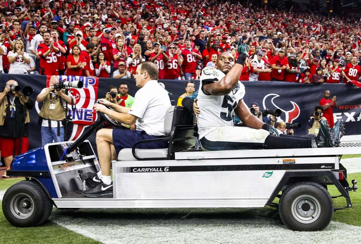 Eagles inside linebacker DeMeco Ryans waves to the crowd as he is carted off the field.