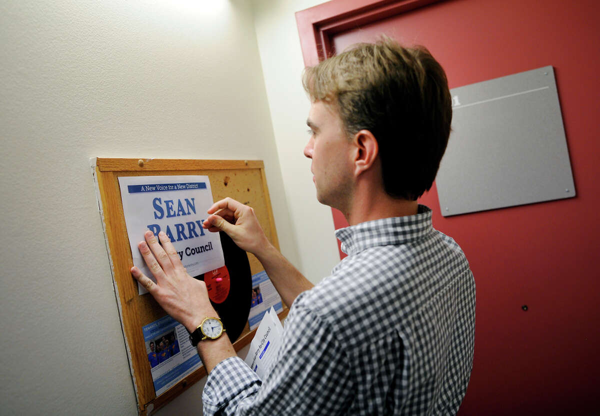 Barry, an alumnus of UC Berkeley, pins a flyer to a message board in the Spens-Black Hall dorms while campaigning on campus.