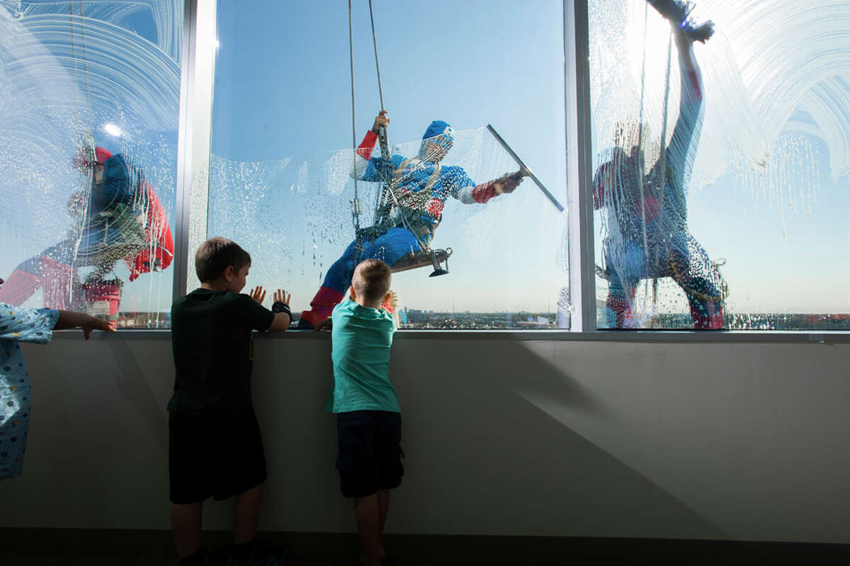 Window washers dressed as superheroes visit kids at Texas Children's ...