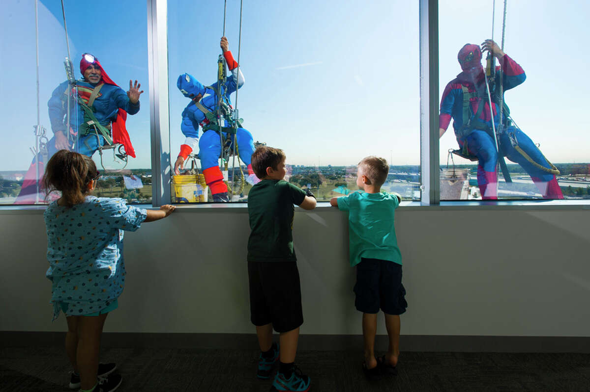 Window washers dressed as superheroes visit kids at Texas Children's ...