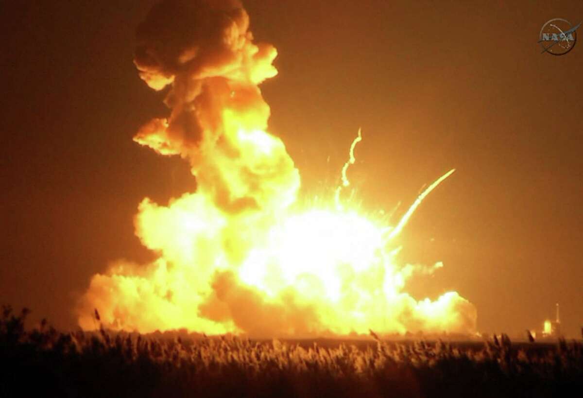 An unmanned rocket explodes at Wallops Island, Virginia, seconds after a Oct. 28 liftoff. Some 5,000 pounds of experiments and equipment for the International Space Station was destroyed.