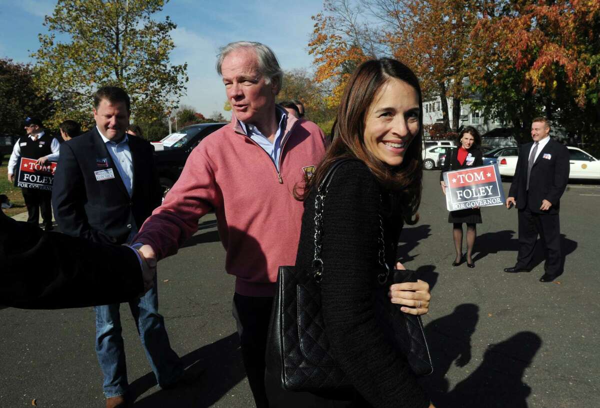 Tom Foley, the Republican candidate for Connecticut governor, makes a campaign stop with his wife, Leslie, at the senior center in Fairfield, Conn. on election day, Tuesday, Nov. 11, 2014. Sen. John McKinney, left, helped Foley greet voters at the poll.