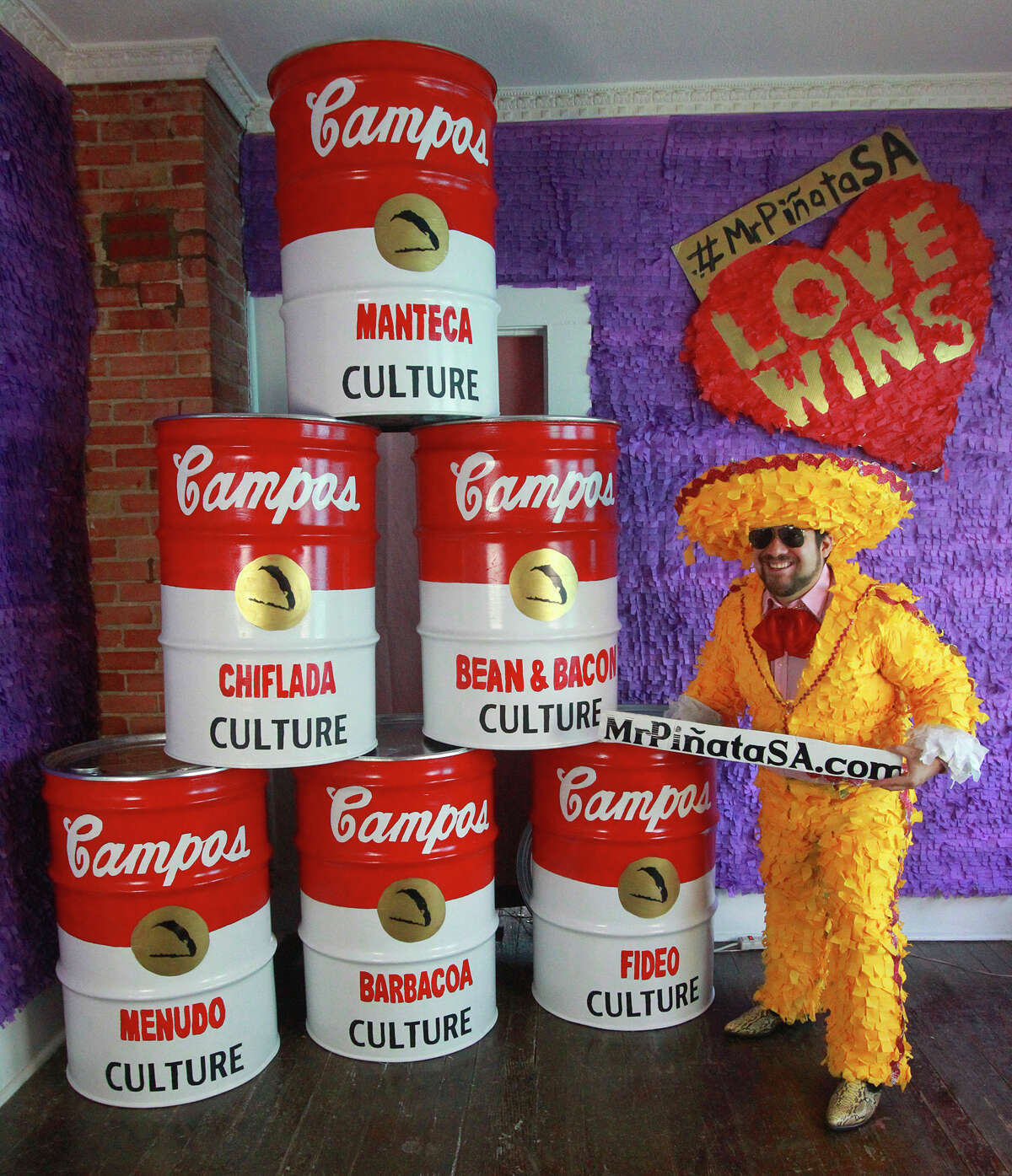 Mr. Pinata shows off soup can sculptures inspired, he says, by San Antonio taco culture and pop art history. 