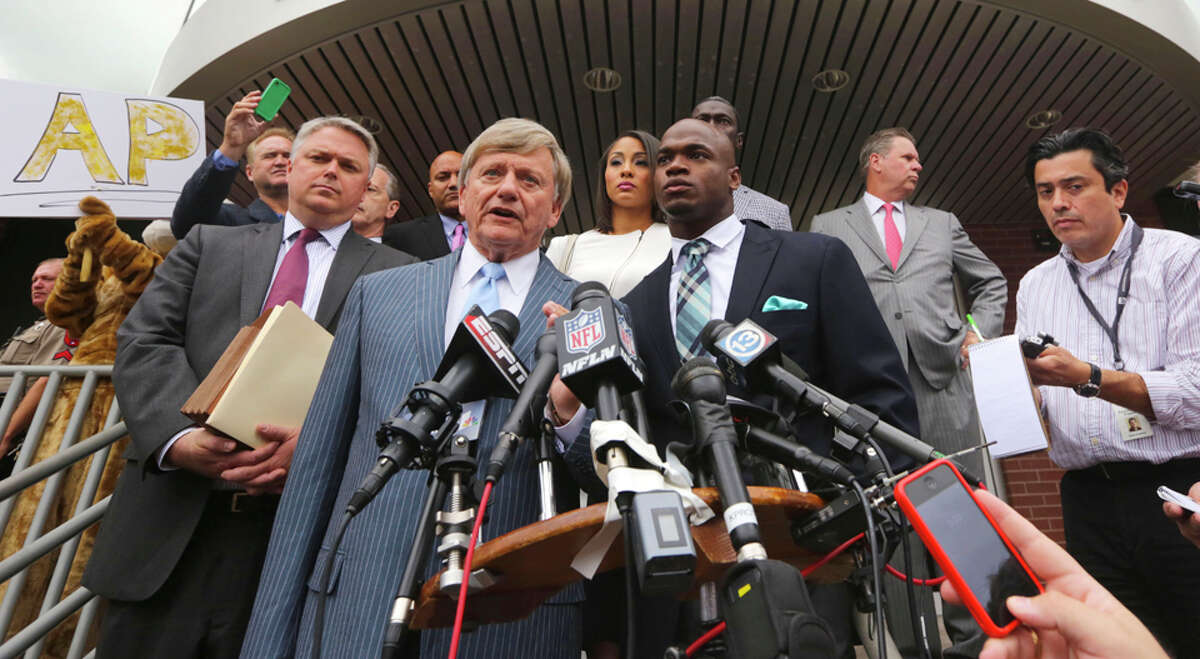 Attorney Rusty Hardin speaks on behalf of his client (right) Minnesota Vikings star running back Adrian Peterson before departing from the Montgomery County courthouse in Conroe, TX Tuesday November 4, 2014. Peterson avoided jail time in a plea agreement reached with prosecutors to resolve his child abuse charge. Peterson's plea to the Class A misdemeanor comes with two years of deferred adjudication. Peterson also received a $4,000 fine and 80 hours of required community service. /