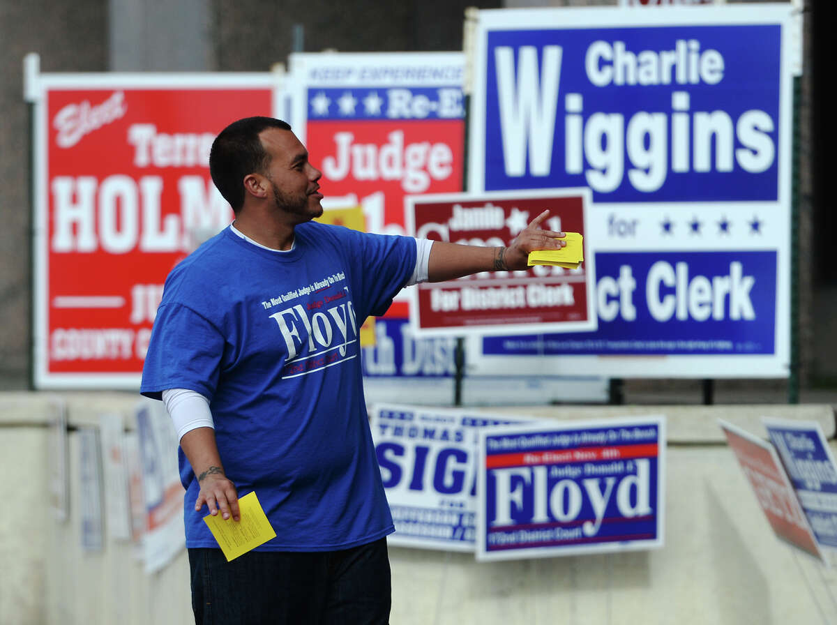 Benjamin Cooper, a volunteer, campaigns for Judge Donald Floyd outside the Jefferson County Courthouse on Monday morning. Photo taken Monday 11/3/14 Jake Daniels/@JakeD_in_SETX