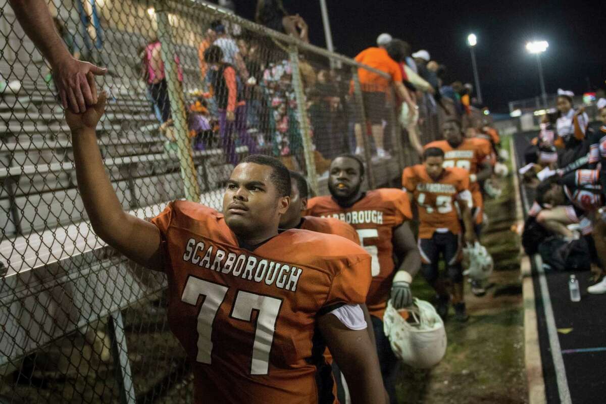 Scarborough Sean Holmes high fives fans after a loss to Furr on senior night at Dyer Stadium on Friday, Nov. 1, 2013, in Houston. Scarborough hasn't won a game since 2009, putting the team in the midst of the longest active losing streak in the state. ( Smiley N. Pool / Houston Chronicle )