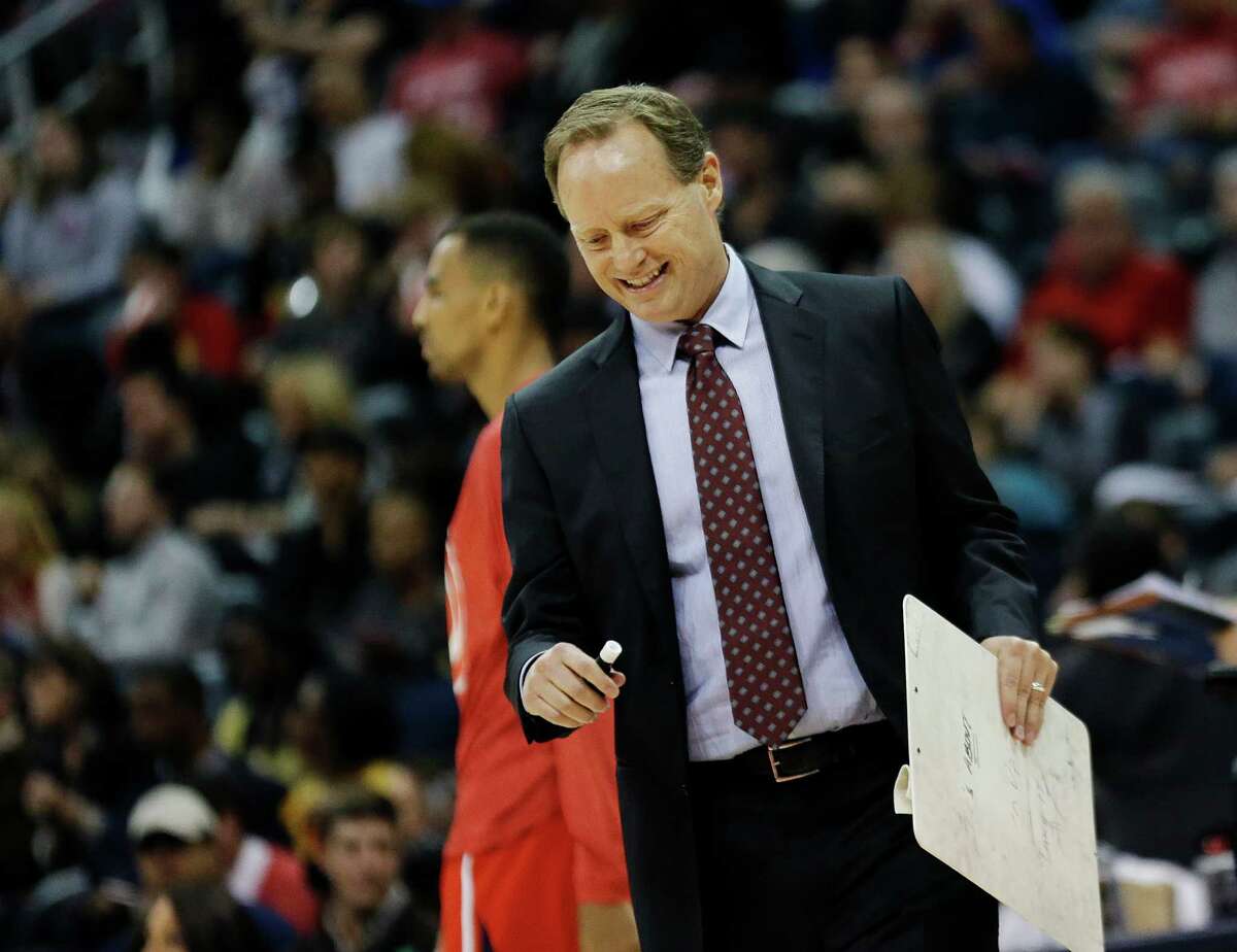 Hawks coach Mike Budenholzer walks onto the court during a timeout in the second half in Atlanta.