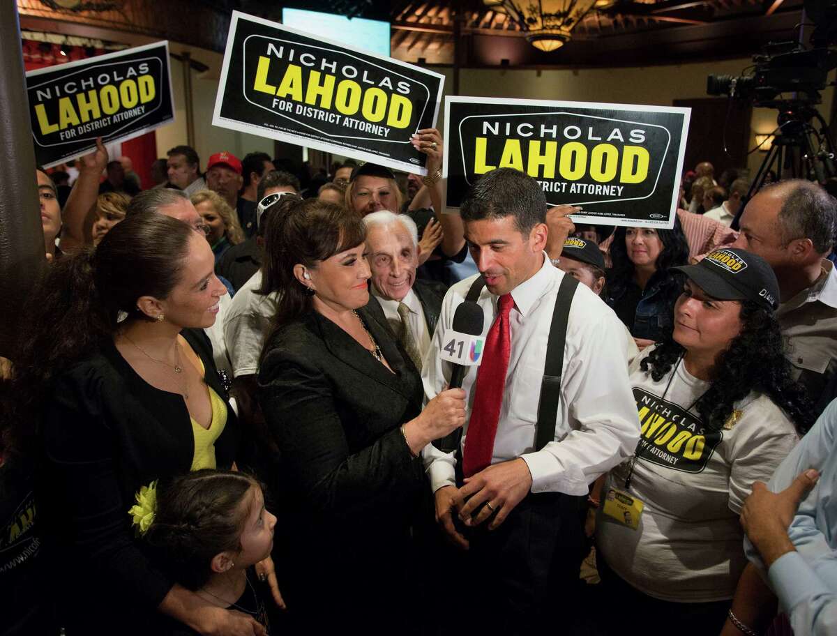 District attorney candidate Nico LaHood, center, andsurrounded by supporters, is interviewed during his election night event, Tuesday, Nov. 4, 2014, in San Antonio as his wife Davida and daughter Maya, 6, both foreground left, look on.
