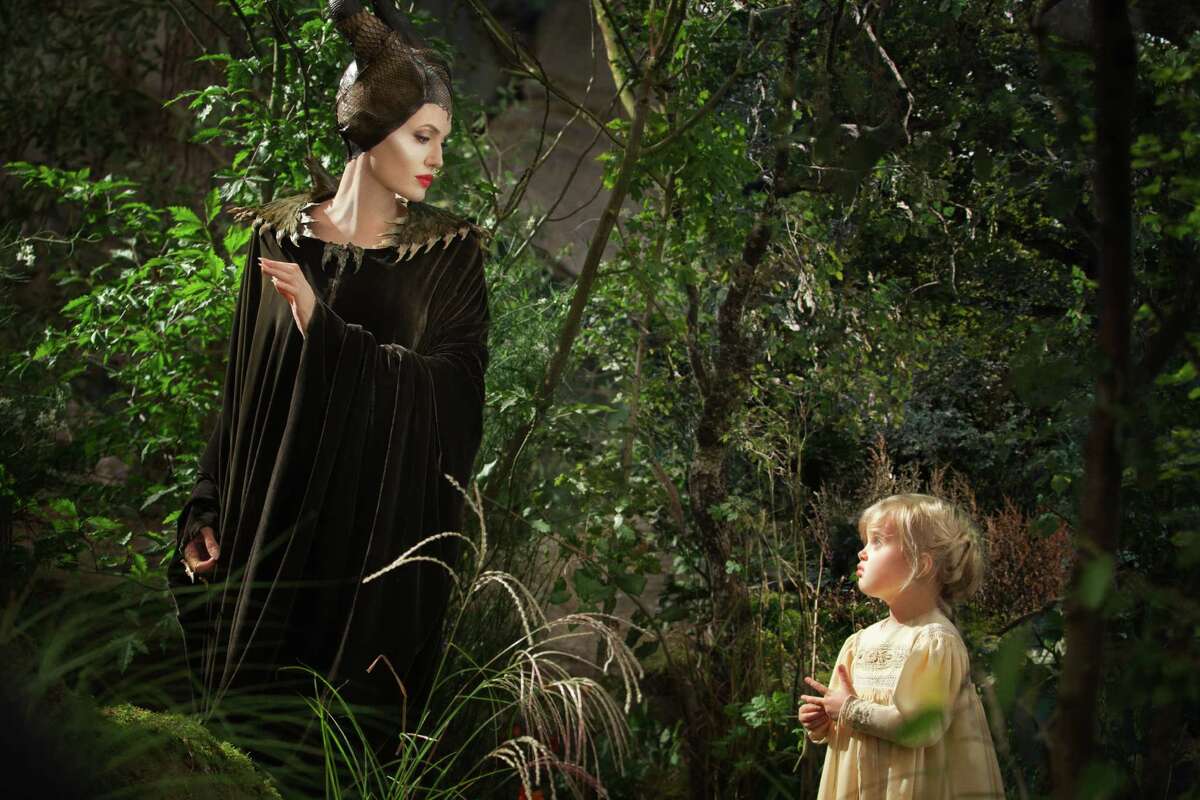 This image released by Disney shows Angelina Jolie as Maleficent, left, in a scene with her daughter Vivienne Jolie-Pitt, portraying Young Aurora, in a scene from the film, "Maleficent." (AP Photo/Disney, Frank Connor)
