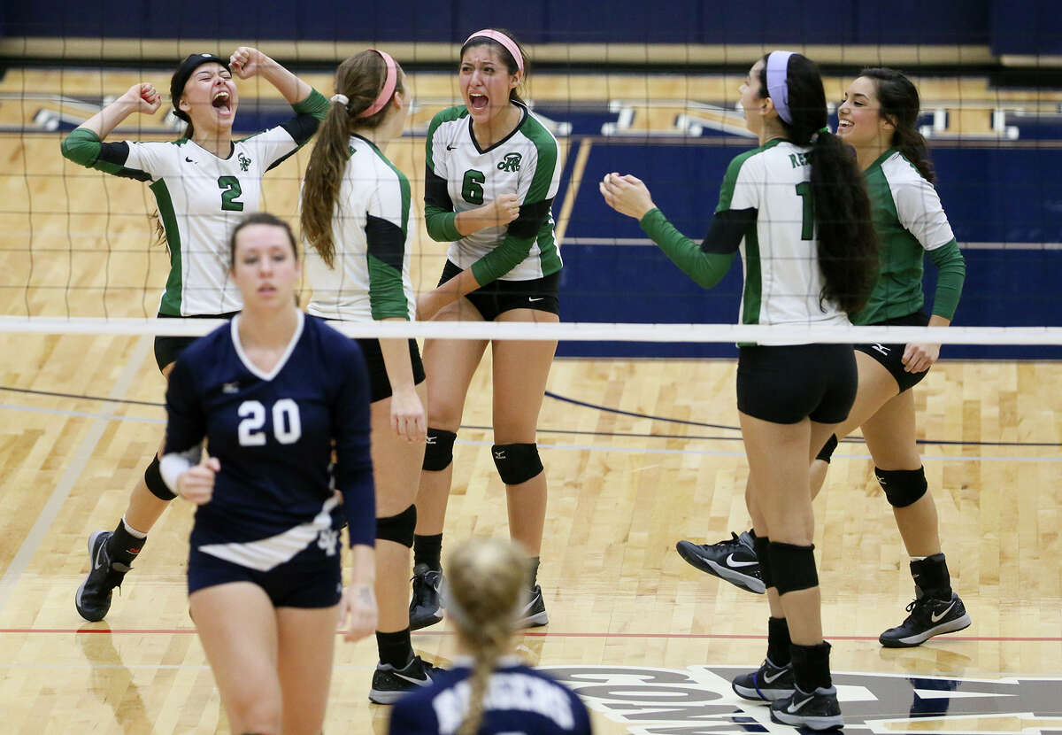 The Reagan Lady Rattlers celebrate a point during their 6A first-round playoff match at Alamo Convocation Center on Nov. 4.