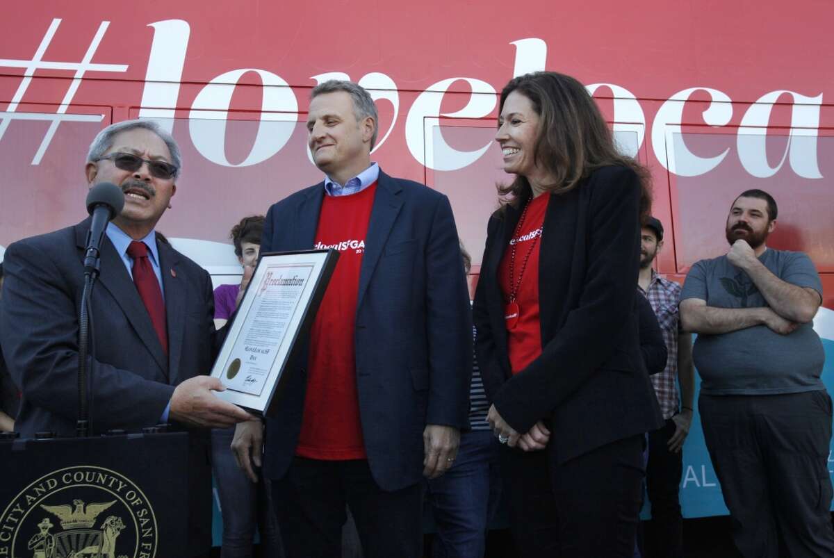 Mayor Ed Lee gives the proclamation kicking off "Love Local SF" day to San Francisco Chronicle Publisher Jeff Johnson, center, and San Francisco Chronicle President Kristine Shine, right, Nov. 5, 2014 at the SF Marin Food Bank in San Francisco, Calif.