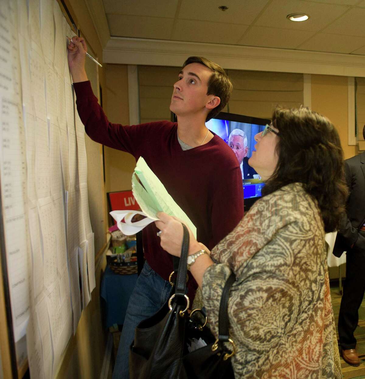 John Grosso puts up election results at the Hampton Inn in Stamford, Conn., on Tuesday, November 4, 2014.