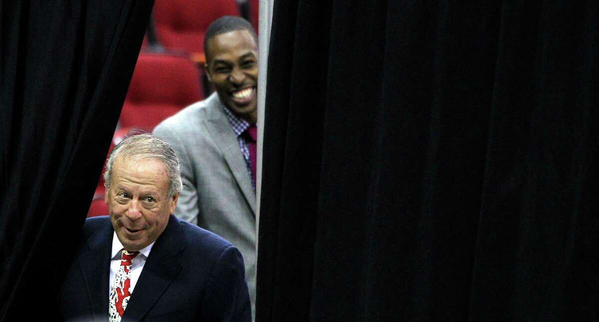 Houston Rocket's owner Les Alexander comes out from behind the curtain as Dwight Howard smiles as he waits for his introduction during the press conference and welcoming ceremony for him, Saturday, July 13, 2013, in Houston. ( Karen Warren / Houston Chronicle )