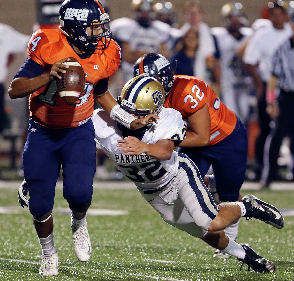 Brandeis’ Paul Lozano looks for running room around O’Connor’s Darren Jasso during first half action Friday Oct. 24, 2014 at Farris Stadium. Lozano was sacked on the play.