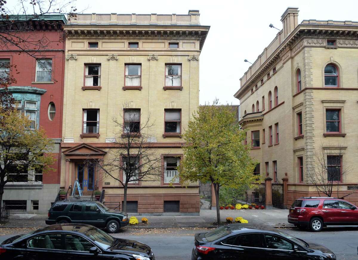 423 State Street, center, on Washington Park shares a courtyard with the Rockefeller, right, Wednesday Nov. 5, 2014, in Albany, NY. SUNY Central System is planning to buy it for $430,000 for the chancellor's residence. She is renting it now at $3,600 monthly from the UAlbany Foundation. (John Carl D'Annibale / Times Union)