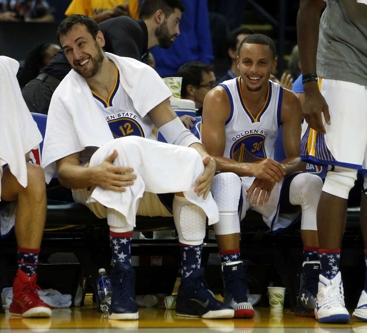 Golden State Warriors' Andrew Bogut and Stephen Curry enjoy themselves on bench late in 4th quarter of Warriors' 121-104 win over the Los Angeles Clippers during NBA game at Oracle Arena in Oakland, Calif., on Wednesday, November 5, 2014.