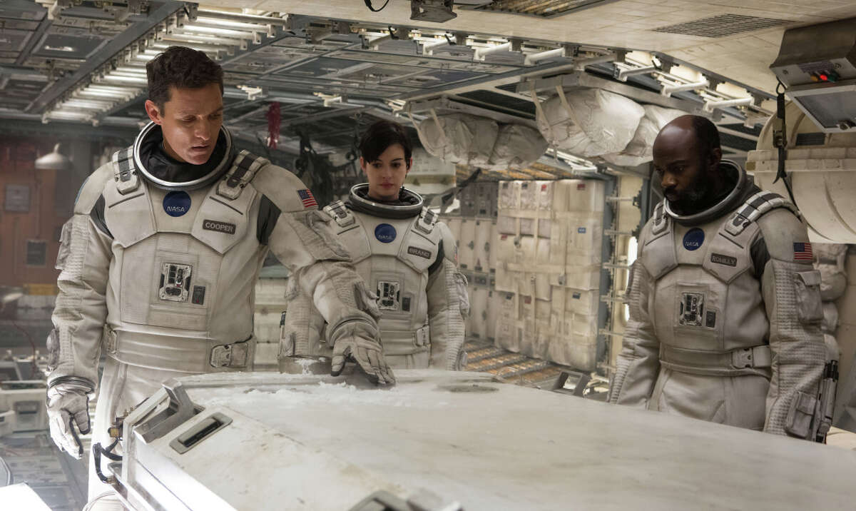 Matthew McConaughey (left) is a space pilot looking for a new home for the dying Earth’s people, in “Interstellar,” with Anne Hathaway and David Gyasi.