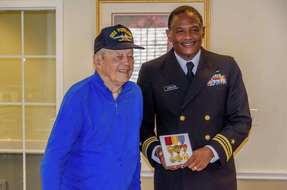 William Speer Jr., 95, receives a new set of Navy medals from Lt. Cmdr. Kenneth Minnard at the Gardens of Bellaire in October. Speer died Nov. 2.