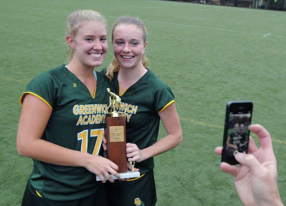 Greenwich Academy players, Haley Carmichael (#17), left, and Katrina Kraus (#4) pose for a photo at the conclusion of the FAA Field Hockey Championship between Greenwich Academy and Rye Country Day School at Greenwich Academy, Conn., Thursday, Nov. 6, 2014. Greenwich took the title with a 1-0 win over RCDS.