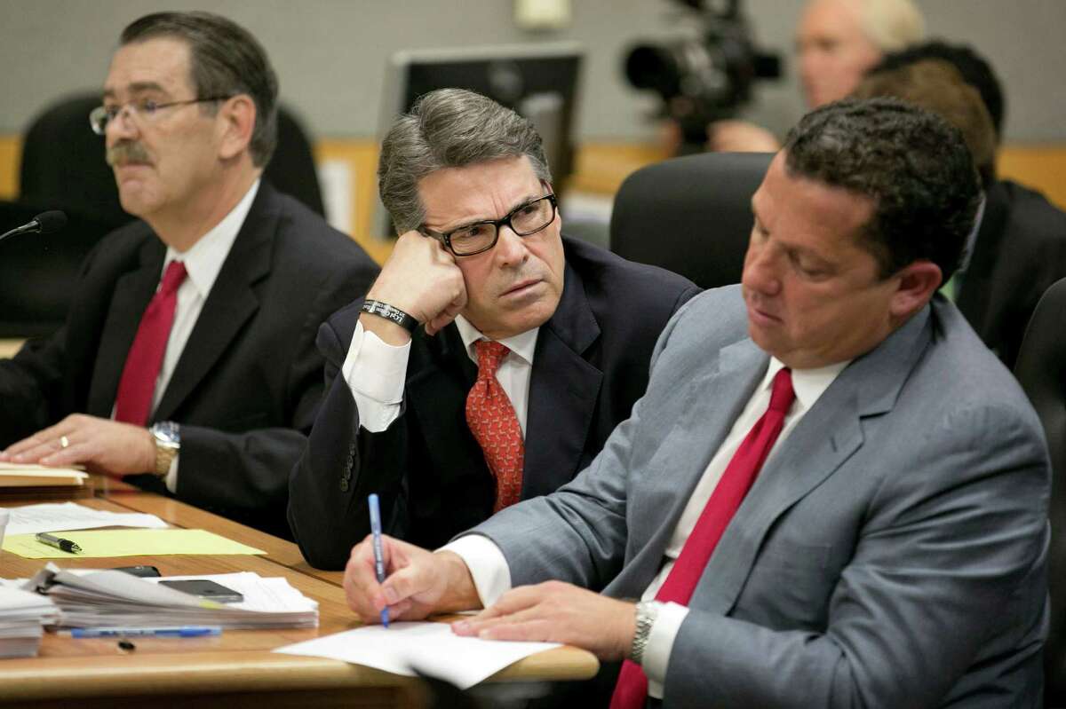 Gov. Rick Perry, flanked by his lawyers Tony Buzbee, right, and David Botsford, stood by the veto that spurred his indictment on abuse of office charges, saying he'd "make that veto again."﻿